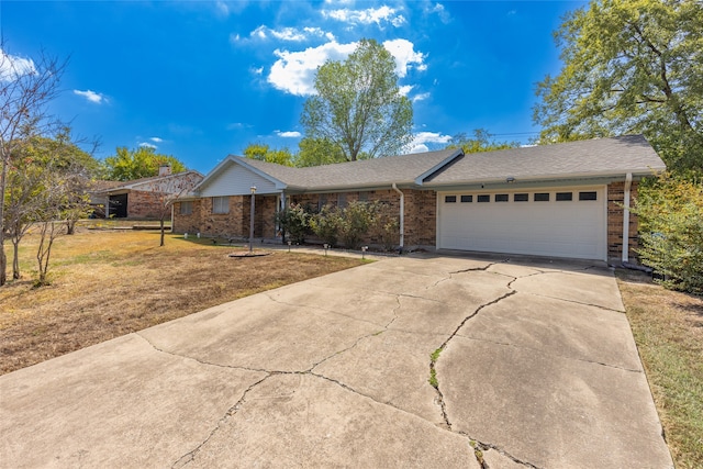 single story home with a front yard and a garage