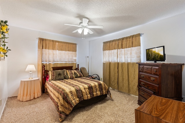 bedroom with a textured ceiling, light carpet, and ceiling fan