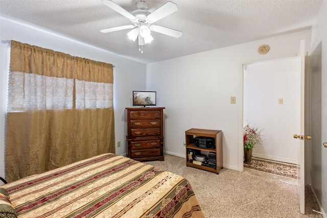 carpeted bedroom featuring a textured ceiling and ceiling fan