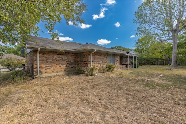 back of house with a lawn