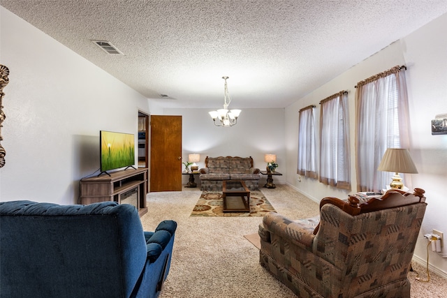 living room with a textured ceiling, light colored carpet, and a notable chandelier