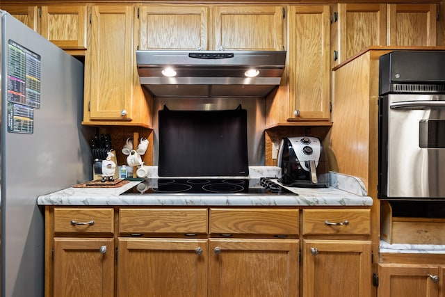 kitchen featuring appliances with stainless steel finishes and extractor fan