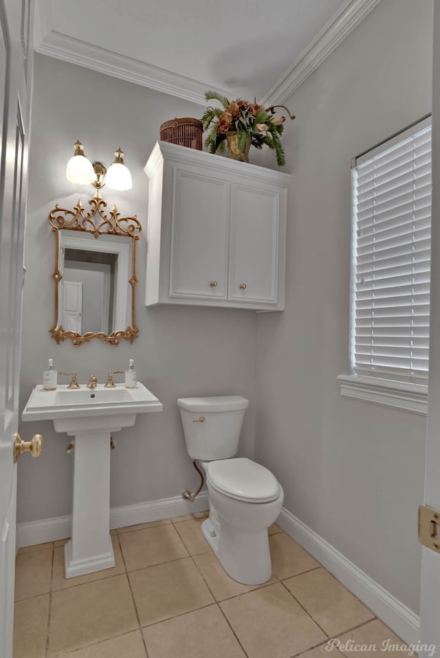 bathroom featuring ornamental molding, tile patterned floors, and toilet