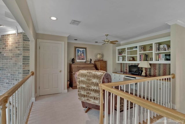 carpeted home office featuring ornamental molding and ceiling fan