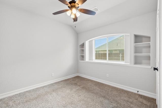 carpeted spare room with vaulted ceiling and ceiling fan