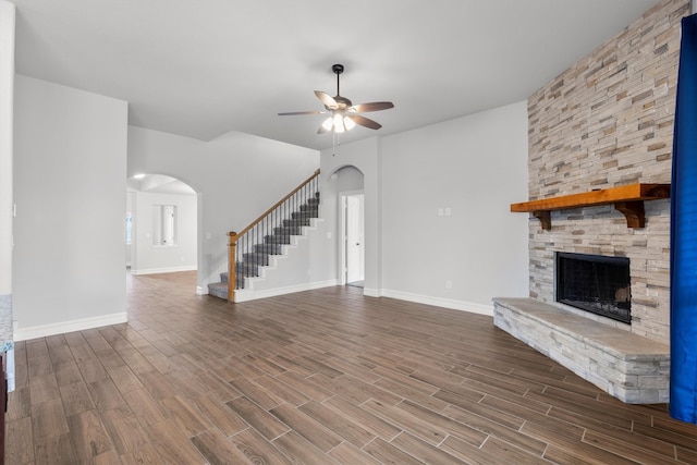 unfurnished living room with ceiling fan, hardwood / wood-style flooring, and a fireplace