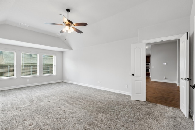 spare room with ceiling fan, lofted ceiling, and wood-type flooring