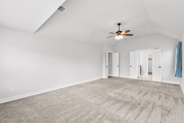 unfurnished bedroom featuring ceiling fan, vaulted ceiling, and carpet flooring