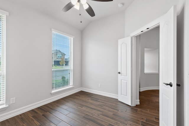 spare room with lofted ceiling, ceiling fan, and dark wood-type flooring