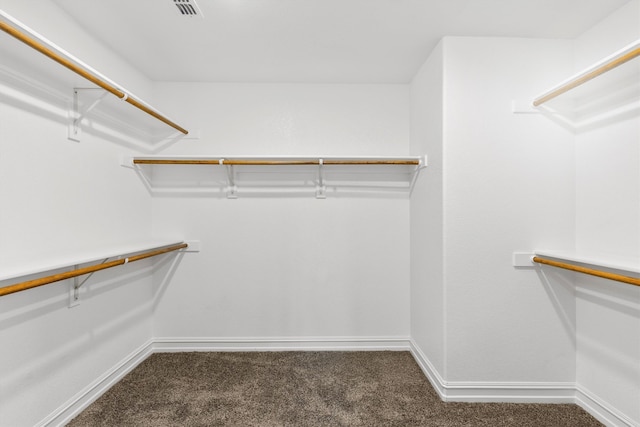 spacious closet featuring dark carpet