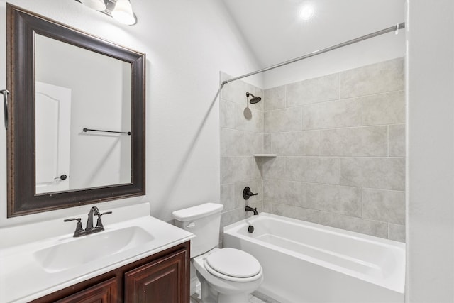 full bathroom featuring tiled shower / bath combo, vanity, and toilet