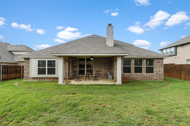 back of house featuring a patio and a yard