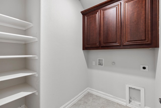 laundry room with washer hookup, cabinets, light tile patterned flooring, electric dryer hookup, and hookup for a gas dryer