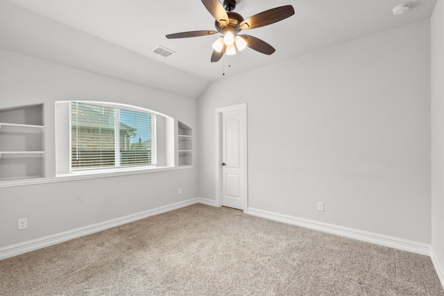 carpeted empty room featuring vaulted ceiling and ceiling fan