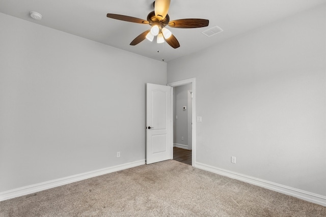 spare room featuring carpet floors and ceiling fan