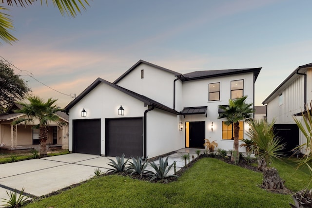 view of front of house featuring a garage and a yard