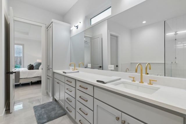 bathroom with a shower with door and vanity