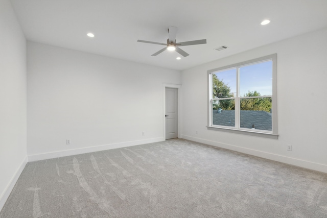 carpeted spare room with ceiling fan