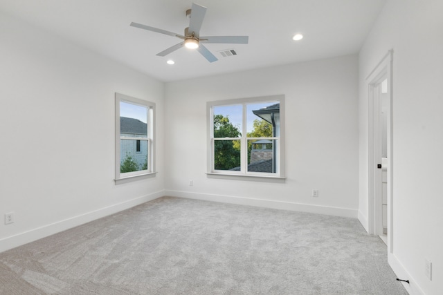 carpeted spare room with ceiling fan