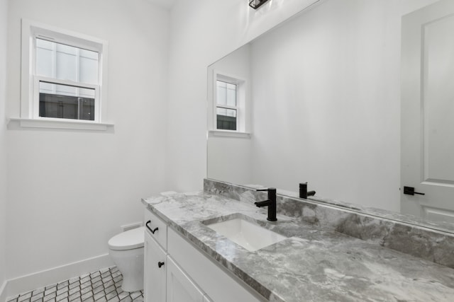 bathroom with vanity, toilet, and tile patterned floors