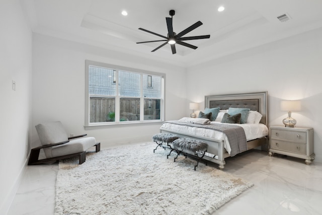 bedroom featuring a tray ceiling and ceiling fan