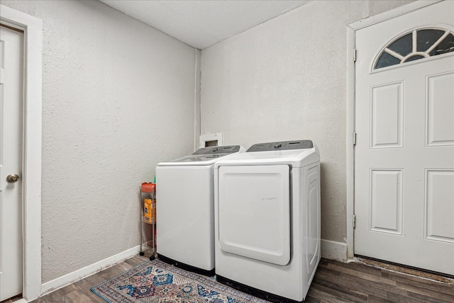 laundry area with separate washer and dryer and dark hardwood / wood-style floors