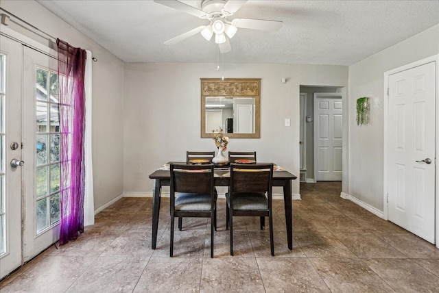 dining room with a textured ceiling and ceiling fan