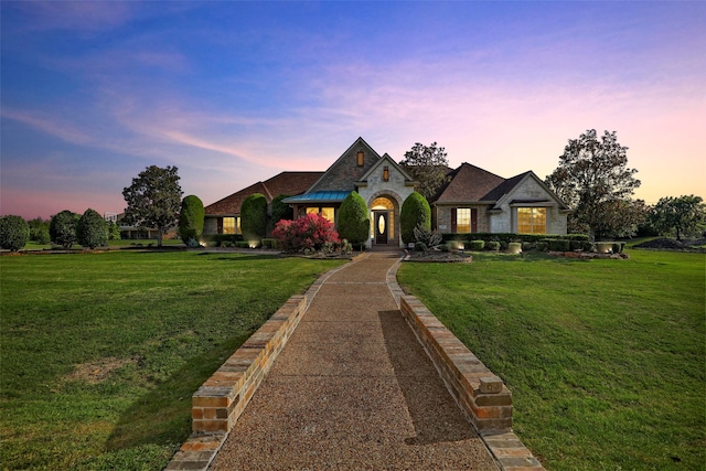 view of front of property with a lawn