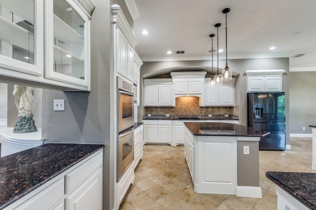 5802 Parker Village Dr, Parker, TX 75002 - kitchen featuring black fridge, crown molding, decorative backsplash, glass insert cabinets, and white cabinets