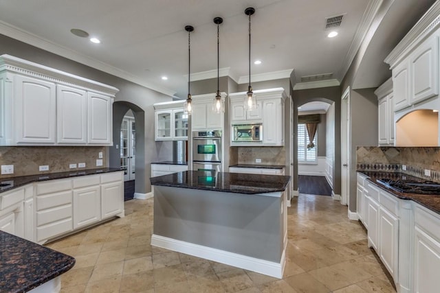 5802 Parker Village Dr, Parker, TX 75002 - kitchen with arched walkways, tasteful backsplash, stainless steel appliances, baseboards, and recessed lighting