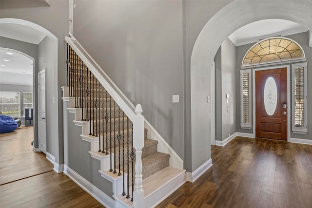 entryway with dark hardwood / wood-style flooring and ornamental molding