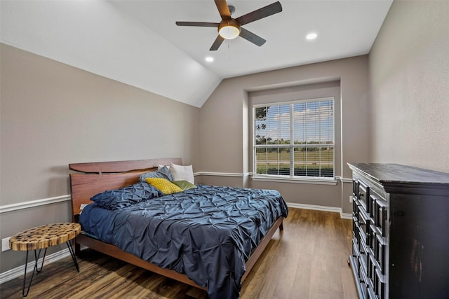 bedroom featuring ceiling fan, dark hardwood / wood-style flooring, and vaulted ceiling