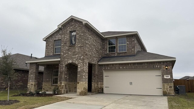 view of front of house featuring central AC unit and a garage