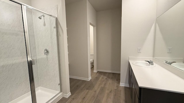 bathroom with hardwood / wood-style floors, toilet, and walk in shower