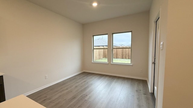 spare room with wood-type flooring