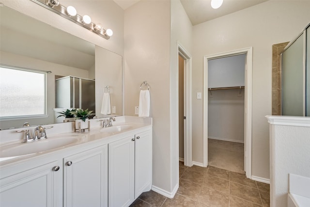 bathroom with vanity, tile patterned floors, and a shower with shower door