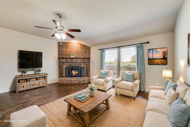 living room with ceiling fan, lofted ceiling, hardwood / wood-style floors, and a fireplace