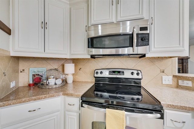 kitchen with white cabinetry, tasteful backsplash, and appliances with stainless steel finishes