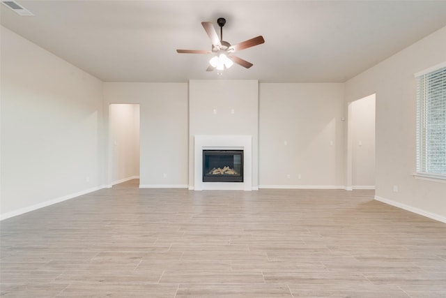 unfurnished living room featuring ceiling fan