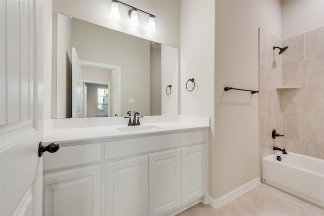 bathroom with tile patterned floors, vanity, and tiled shower / bath