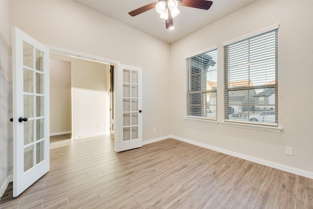 empty room featuring ceiling fan, light hardwood / wood-style flooring, and french doors