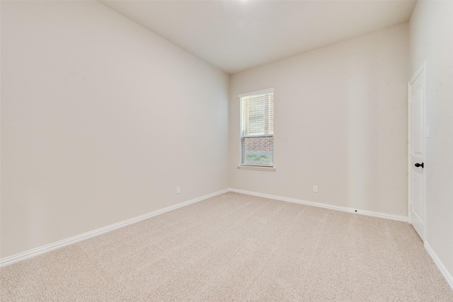 unfurnished room featuring light colored carpet