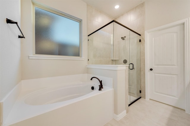 bathroom featuring separate shower and tub and tile patterned flooring