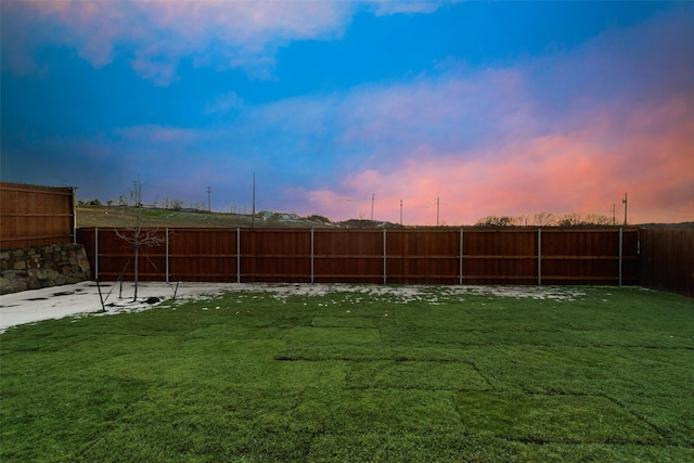 yard at dusk with a patio area