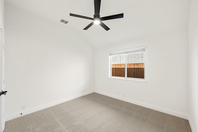 spare room featuring carpet, ceiling fan, and lofted ceiling