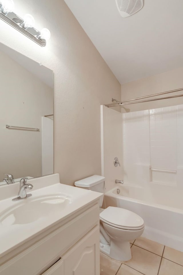 full bathroom featuring tile patterned floors, lofted ceiling, toilet, vanity, and bathtub / shower combination