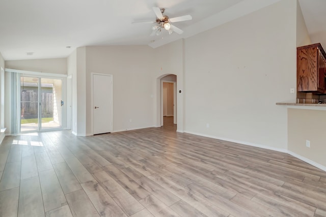 unfurnished living room featuring ceiling fan, light hardwood / wood-style flooring, and high vaulted ceiling