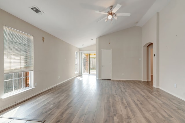 empty room featuring ceiling fan, light hardwood / wood-style flooring, and vaulted ceiling