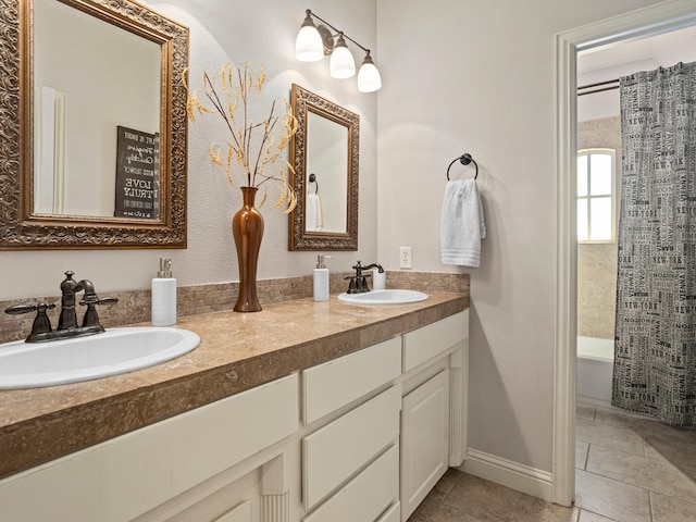 bathroom with shower / tub combo, vanity, and tile patterned floors