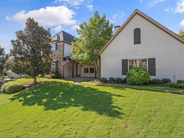7005 Shinnecock Hills Dr, Fort Worth, TX 76132 - view of front of property with a front lawn, a chimney, and brick siding